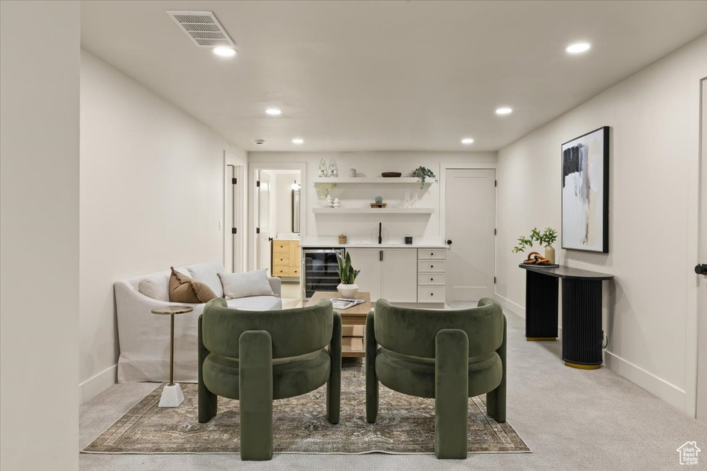 Living room with recessed lighting, light carpet, and baseboards