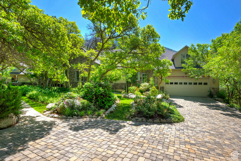 Obstructed view of property featuring an attached garage and driveway