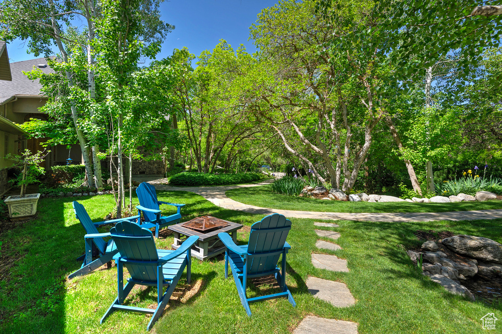 View of green lawn with a fire pit
