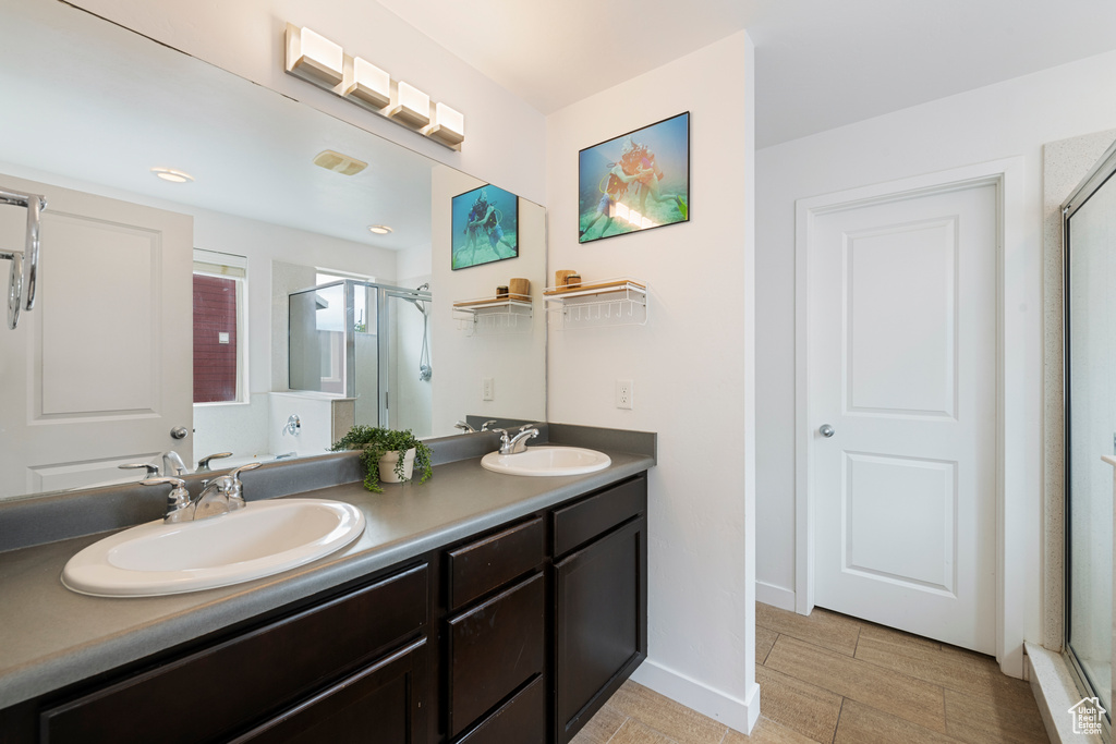 Full bath with a stall shower and double vanity