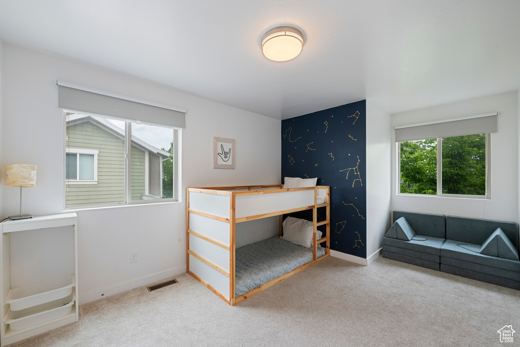 Bedroom with multiple windows, carpet, and baseboards