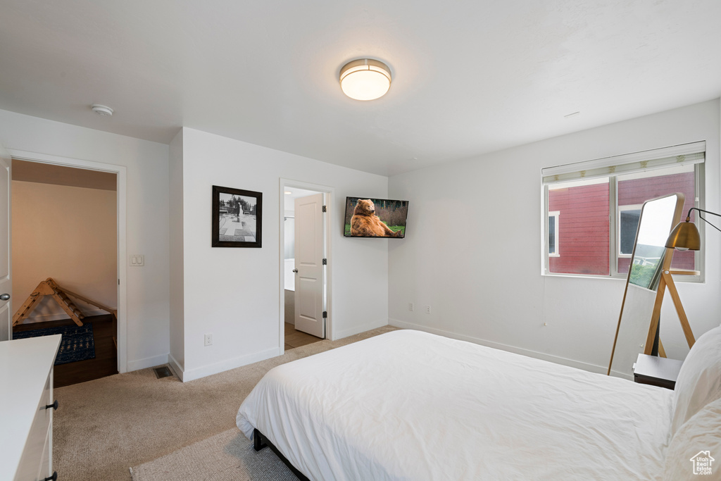 Carpeted bedroom with baseboards