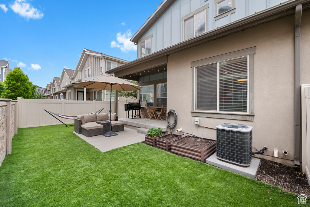 View of yard with central AC unit and a patio area