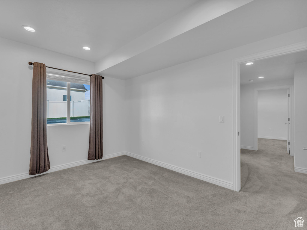 Empty room featuring carpet flooring, recessed lighting, and baseboards