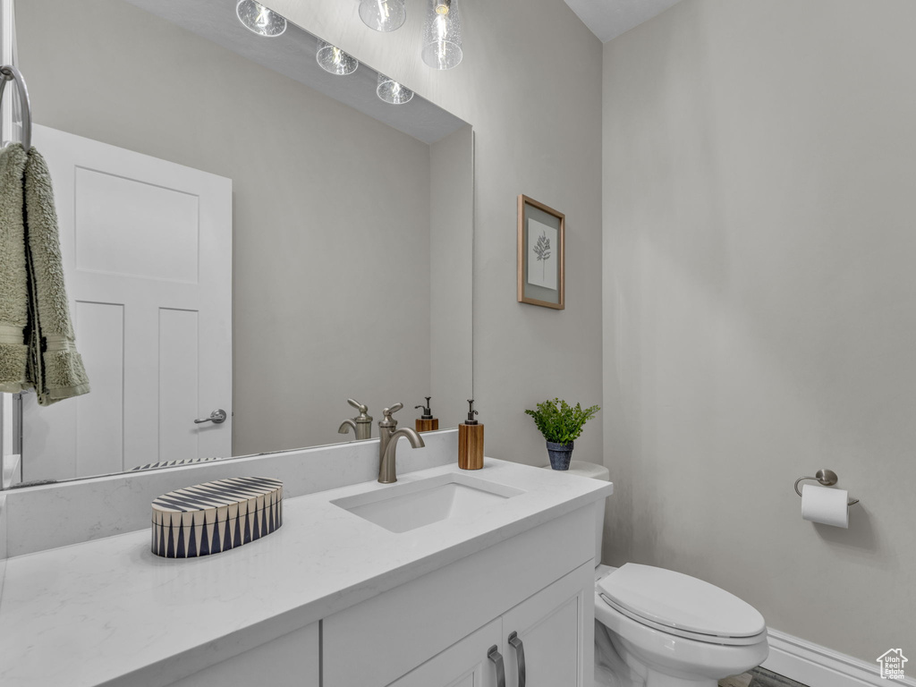 Half bathroom featuring toilet and vanity