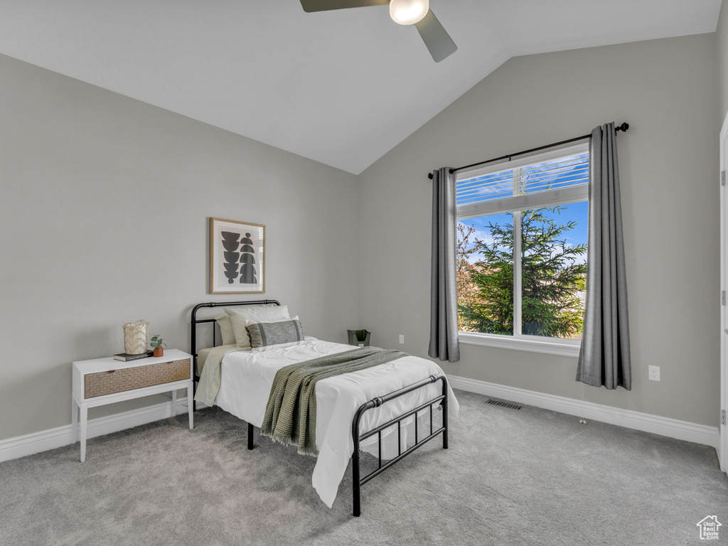 Bedroom featuring lofted ceiling, baseboards, carpet, and ceiling fan