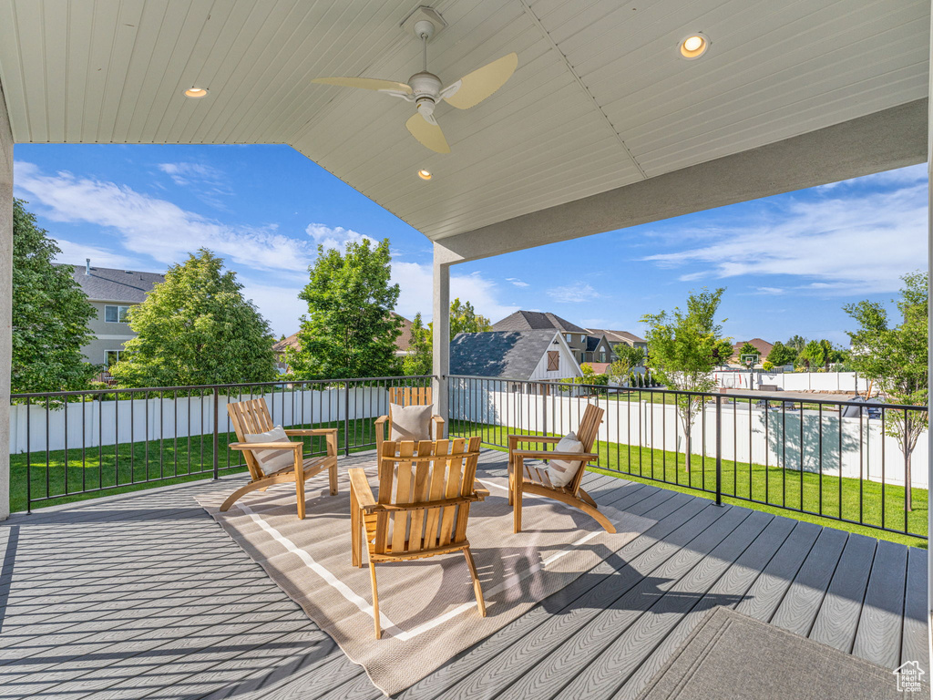 Wooden terrace featuring a residential view and a ceiling fan