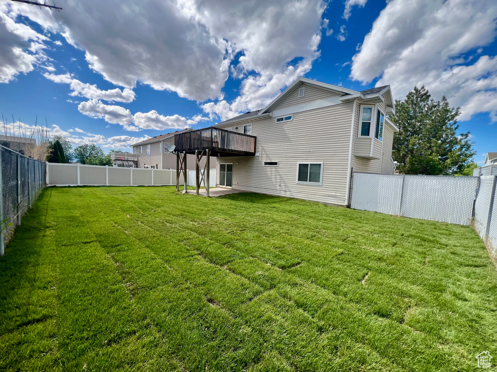 Back of property with a deck and a patio area