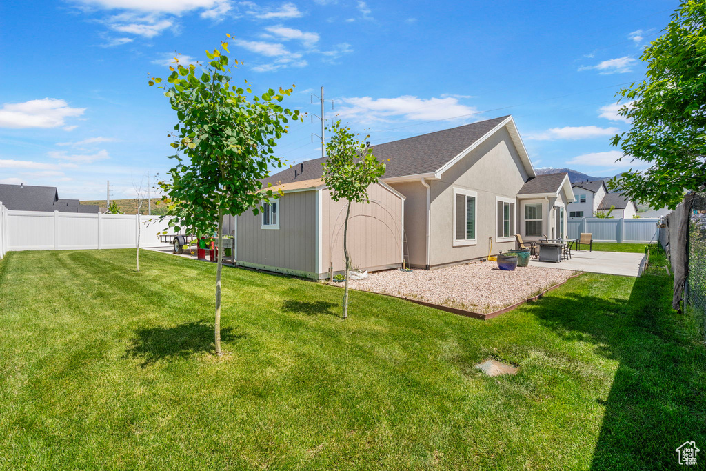 Back of property with a patio area and stucco siding