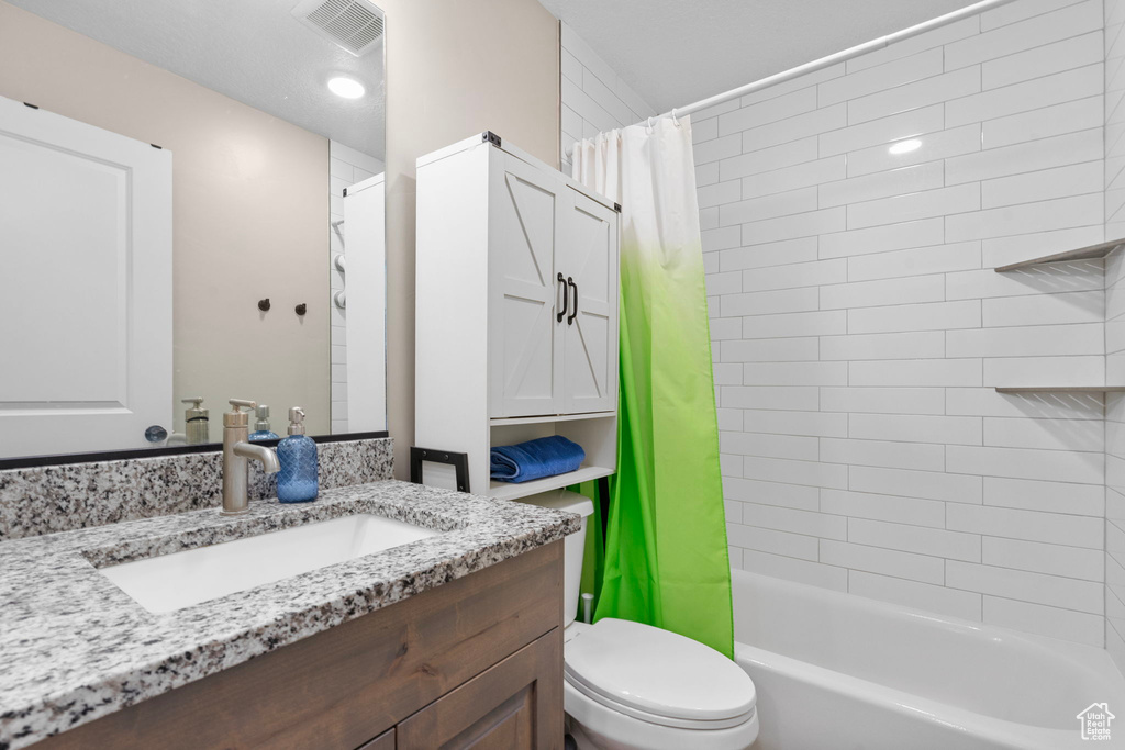 Full bath featuring toilet, shower / tub combo, and vanity