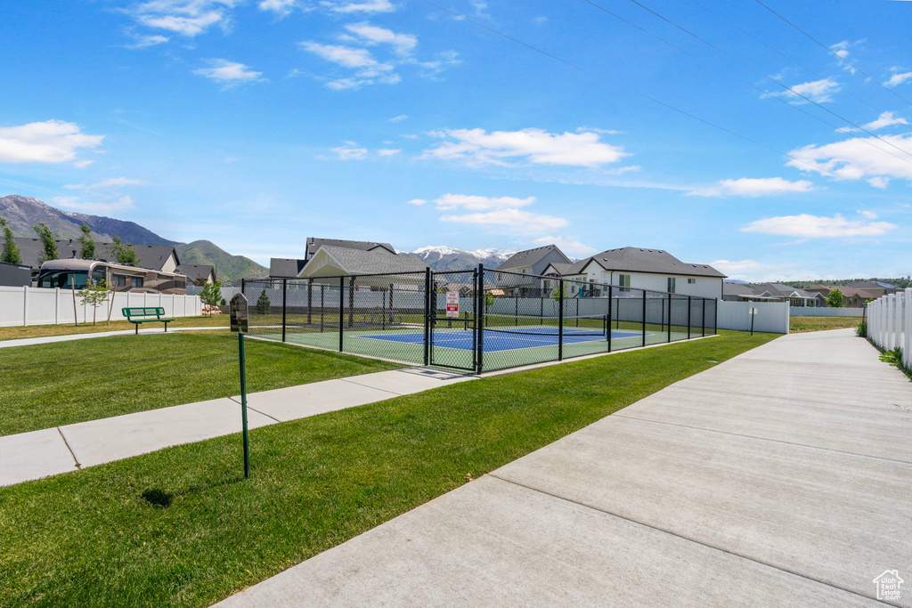 View of community featuring a residential view, a tennis court, a mountain view, and a gate