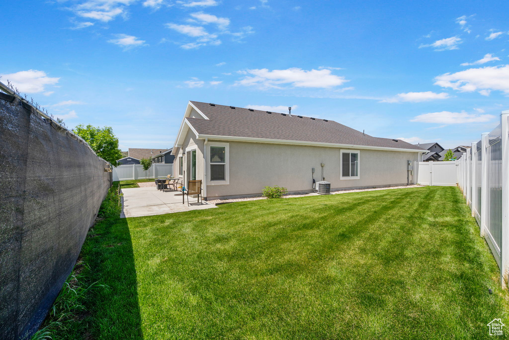Back of property with a patio, stucco siding, and central AC unit