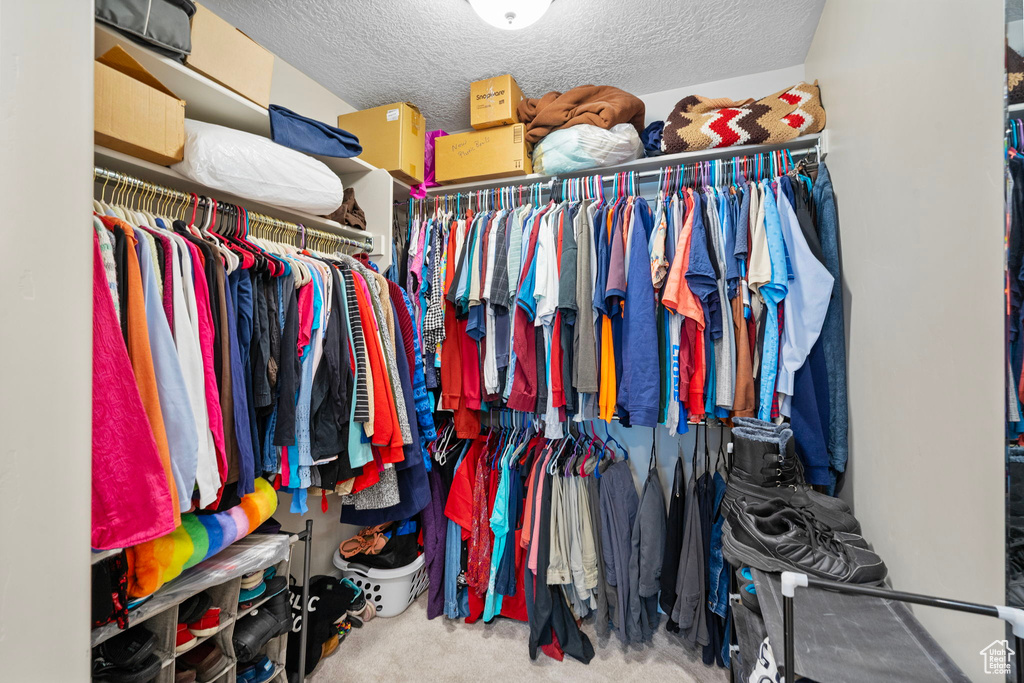 Walk in closet featuring carpet flooring