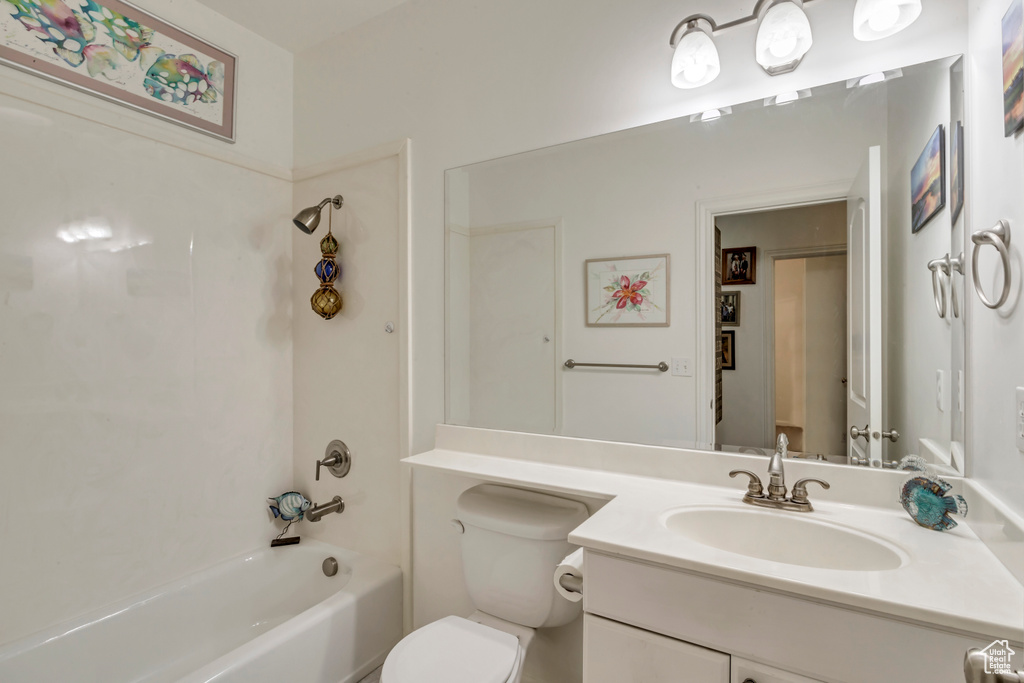 Bathroom featuring vanity, toilet, and bathing tub / shower combination