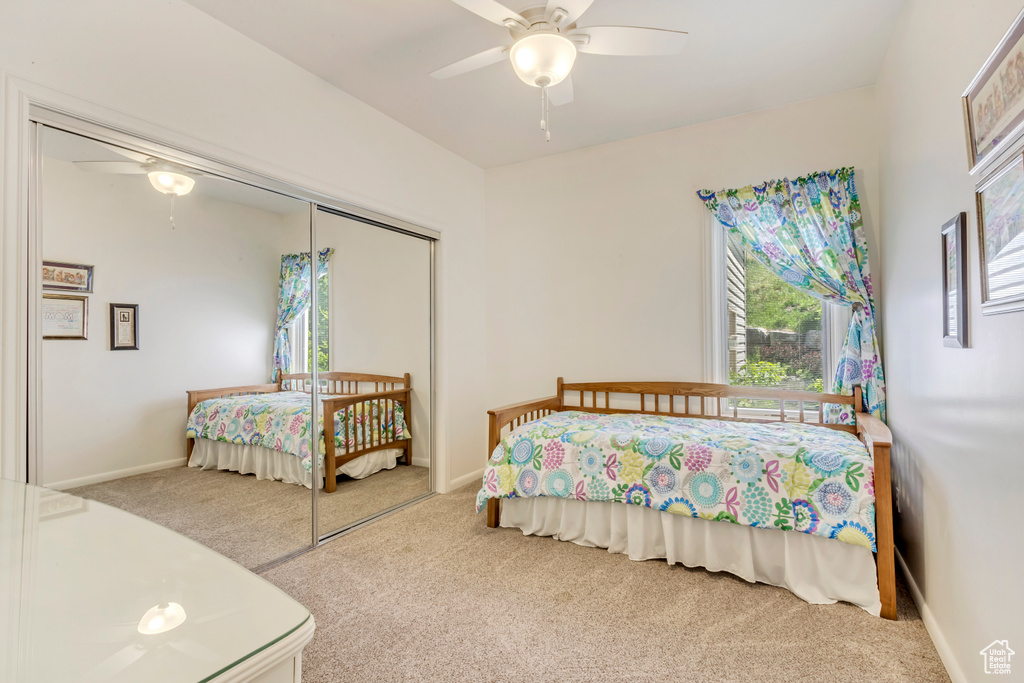 Bedroom featuring carpet, a closet, ceiling fan, and baseboards