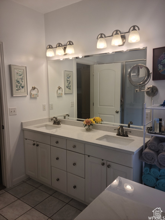 Bathroom featuring tile patterned floors and double vanity