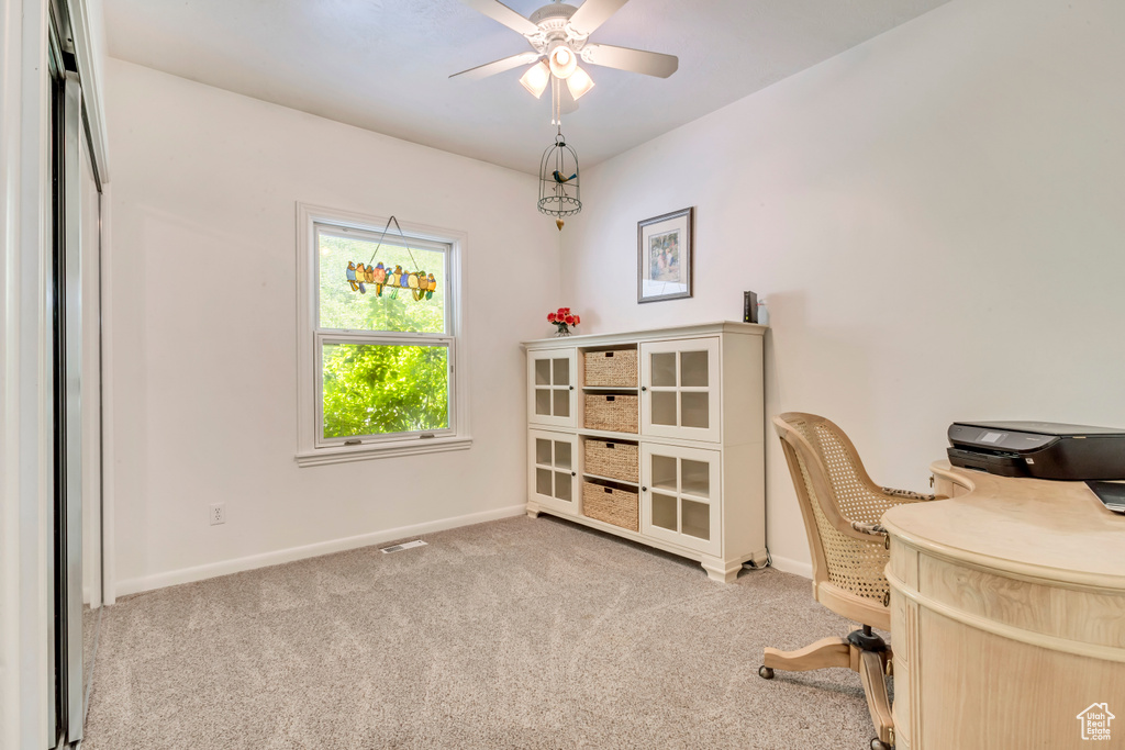 Home office featuring baseboards, carpet, and a ceiling fan
