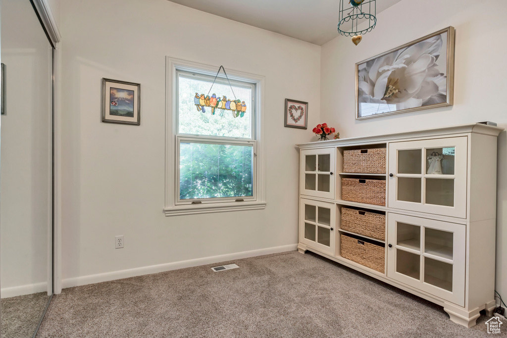 Unfurnished dining area featuring carpet floors and baseboards