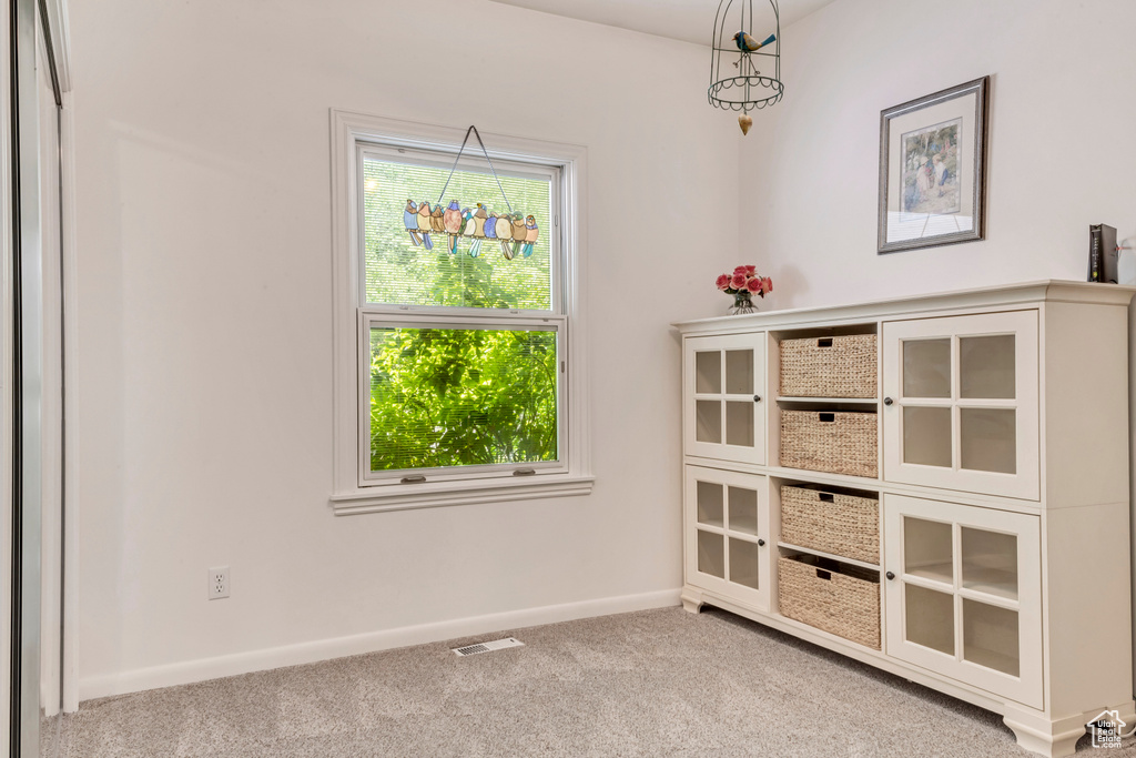 Unfurnished dining area featuring carpet floors and baseboards
