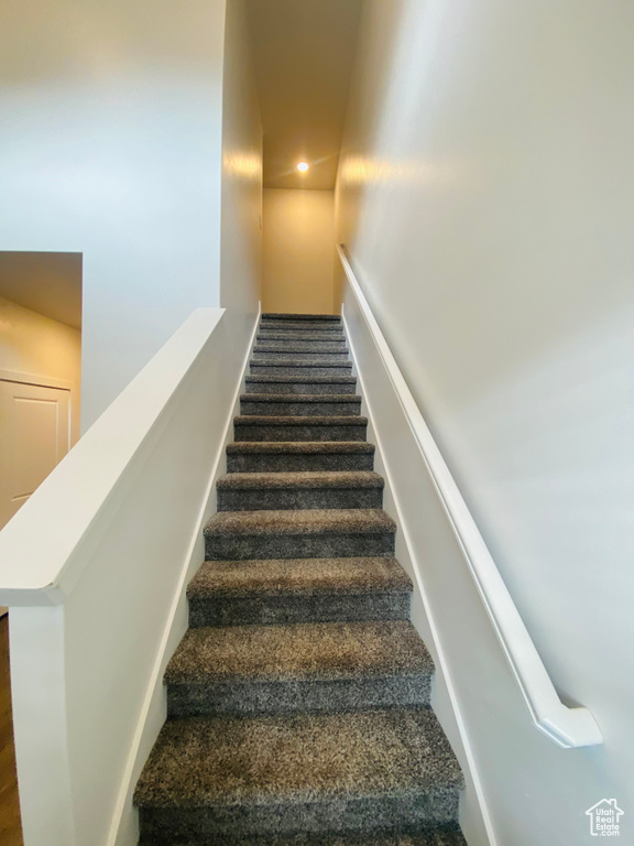 Stairs featuring recessed lighting and carpet flooring