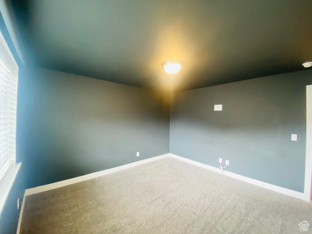 Spare room with carpet floors and baseboards