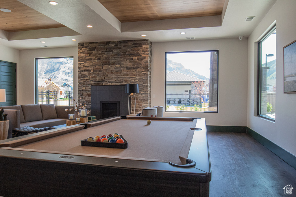Recreation room with a raised ceiling, wood finished floors, billiards table, baseboards, and wood ceiling