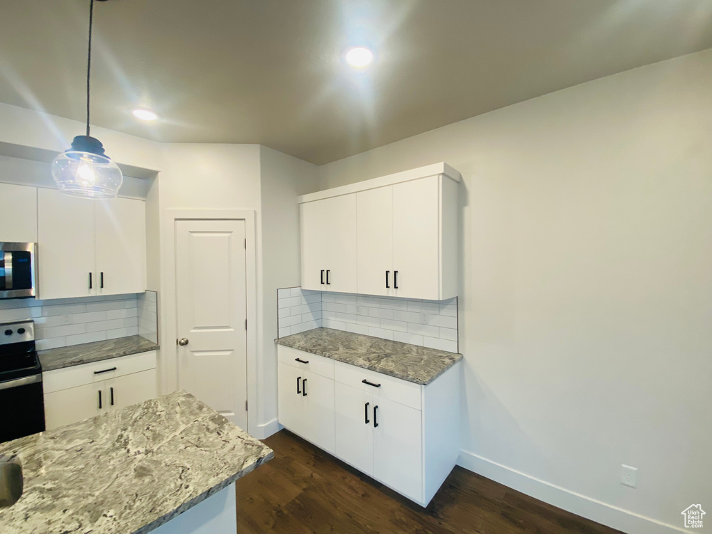 Kitchen featuring appliances with stainless steel finishes, baseboards, dark wood-style flooring, tasteful backsplash, and recessed lighting