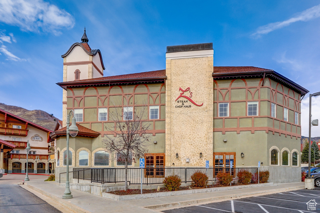 View of property with uncovered parking