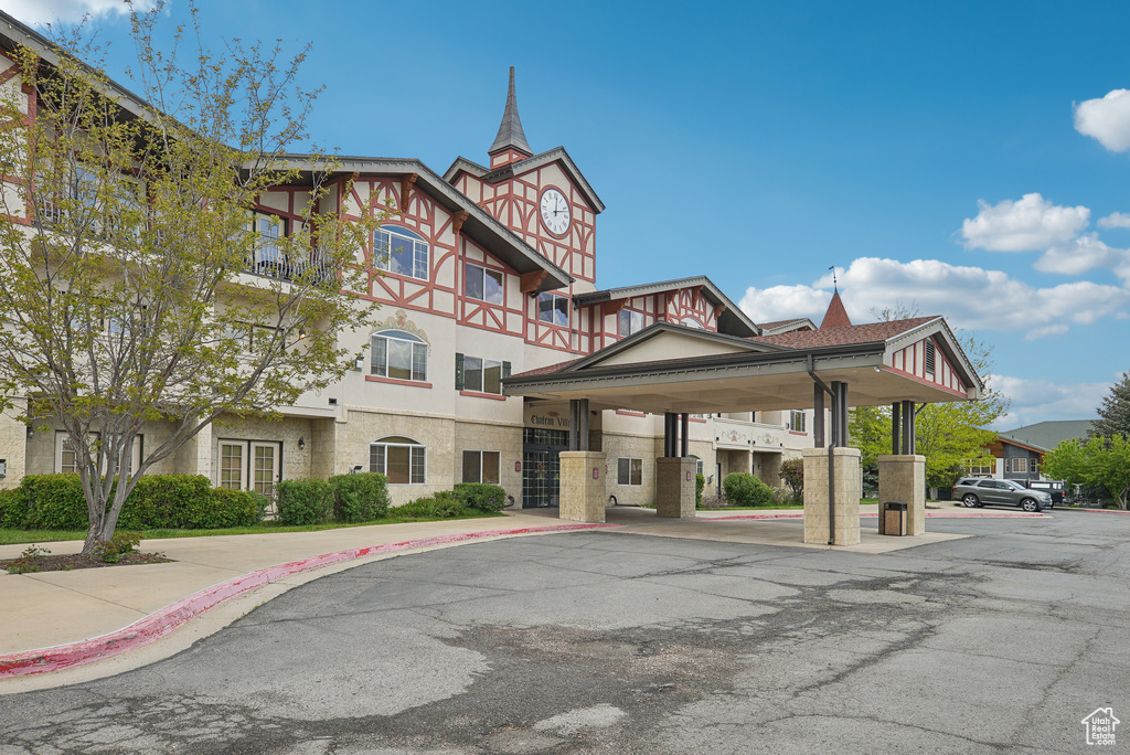 View of property featuring uncovered parking