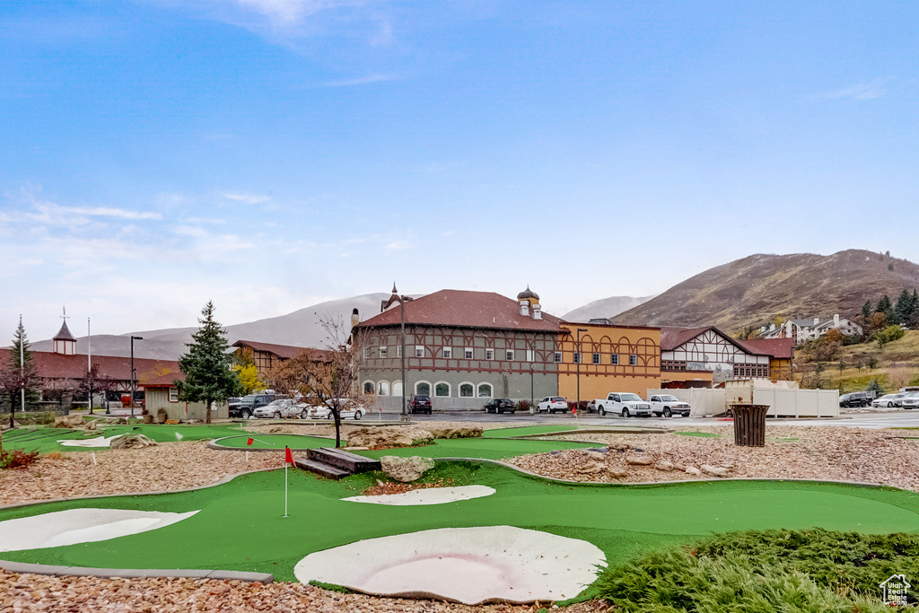 View of home's community with a putting green and a mountain view