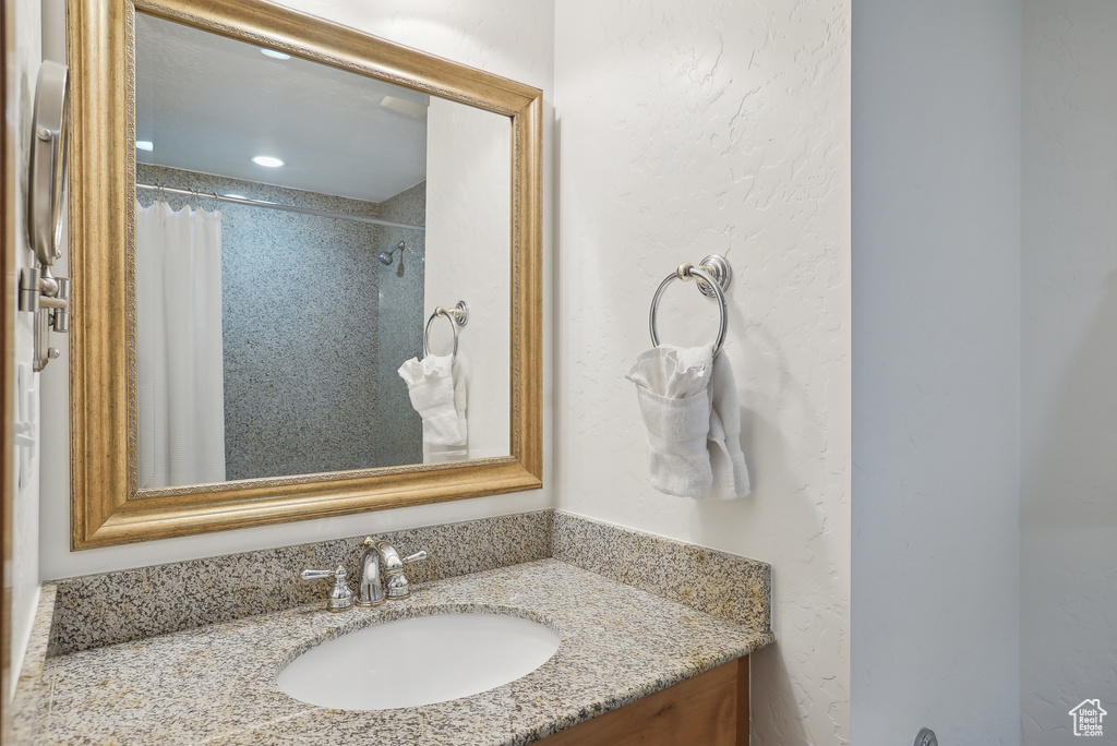Full bathroom with vanity and curtained shower