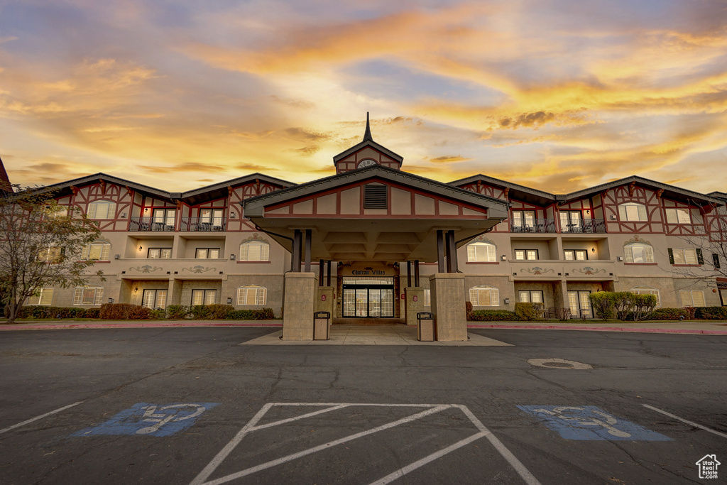 View of building exterior with uncovered parking