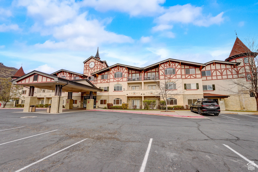 View of property featuring uncovered parking