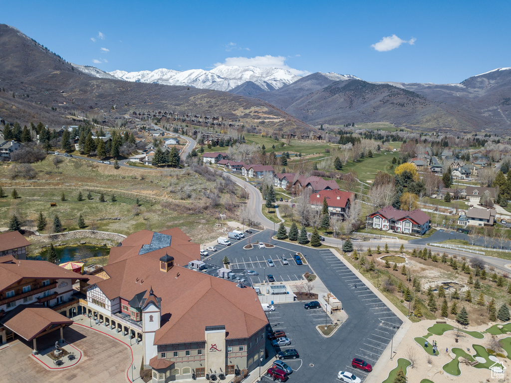 Aerial view of property and surrounding area featuring a mountain backdrop