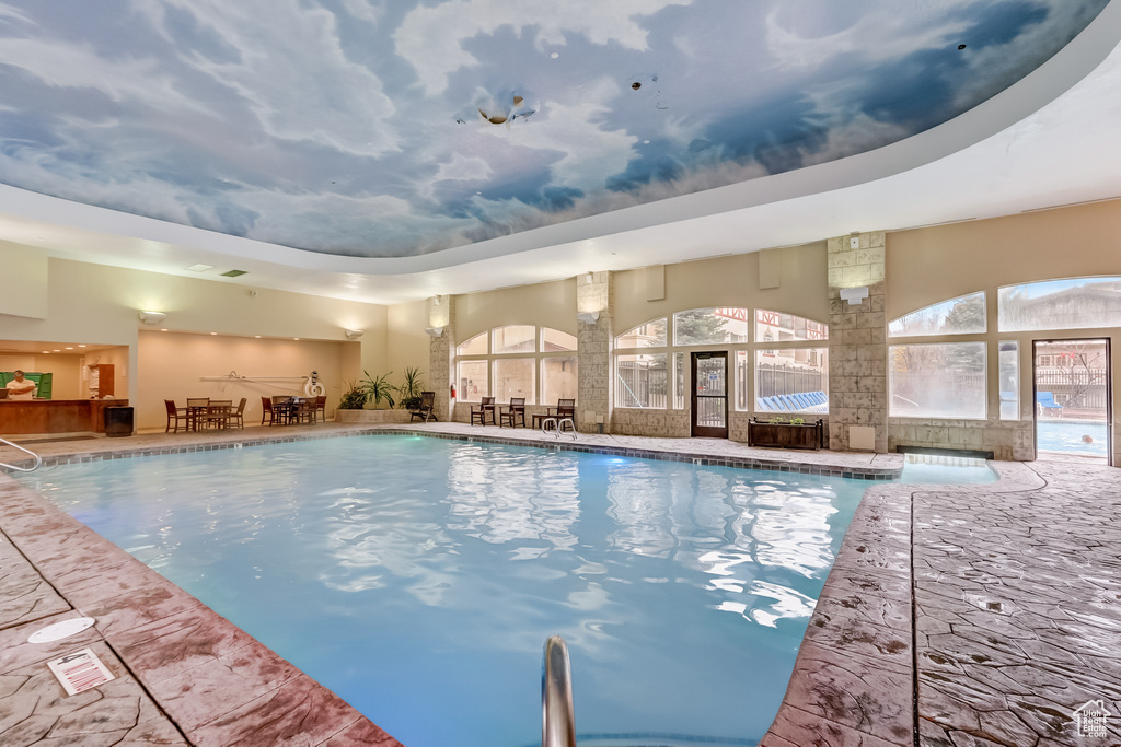 Indoor pool featuring outdoor dining area and a patio area