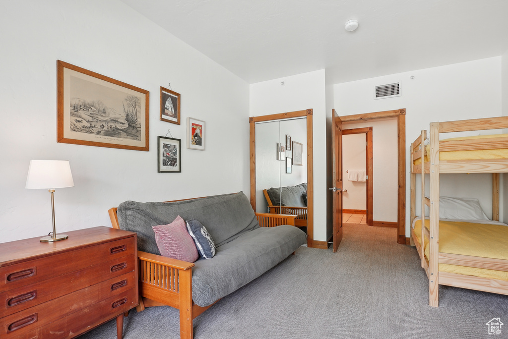 Bedroom featuring light colored carpet