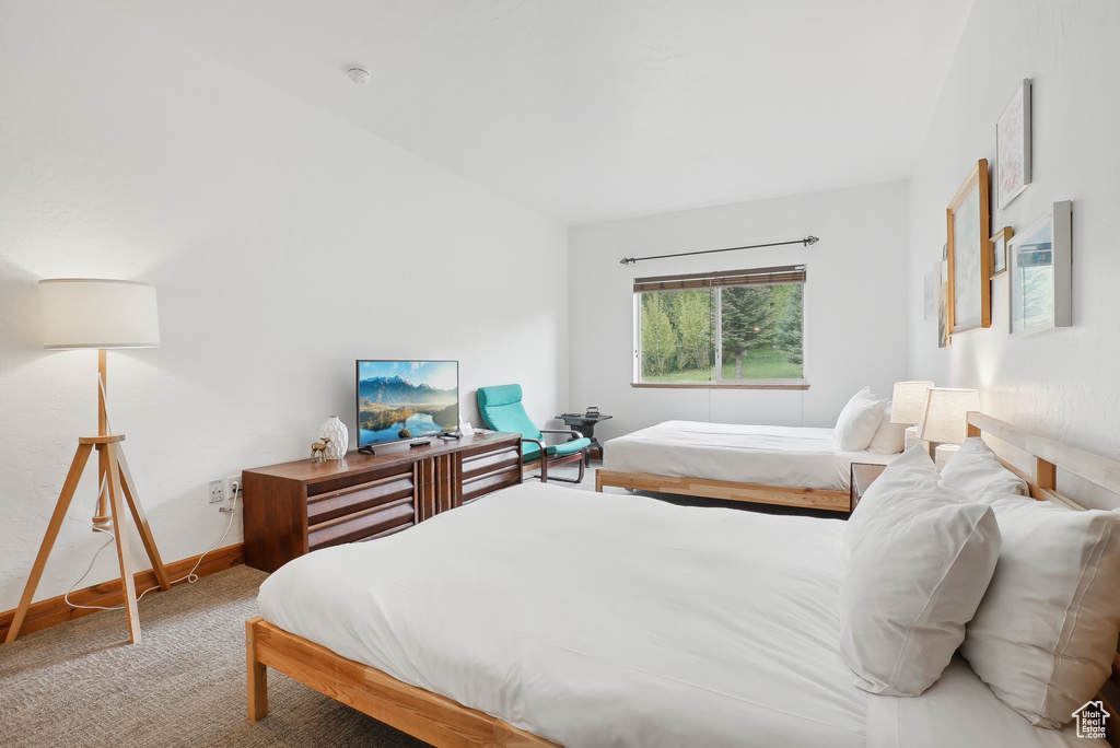Carpeted bedroom featuring baseboards