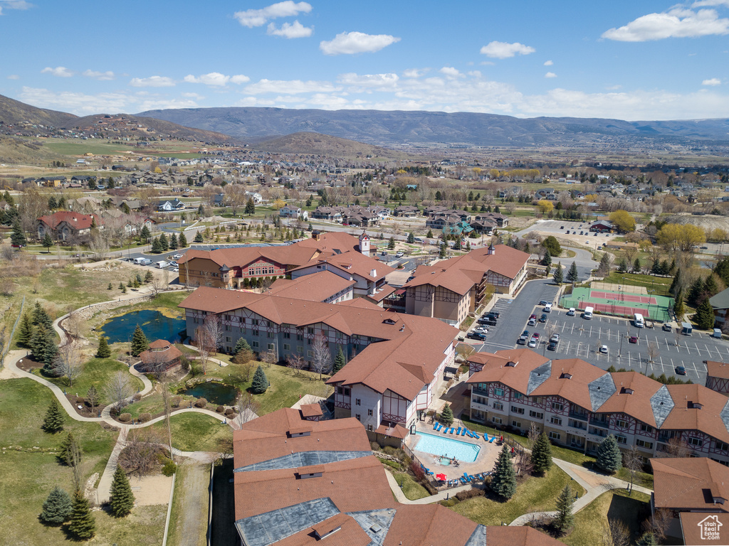 Aerial overview of property's location with a mountainous background and a pool