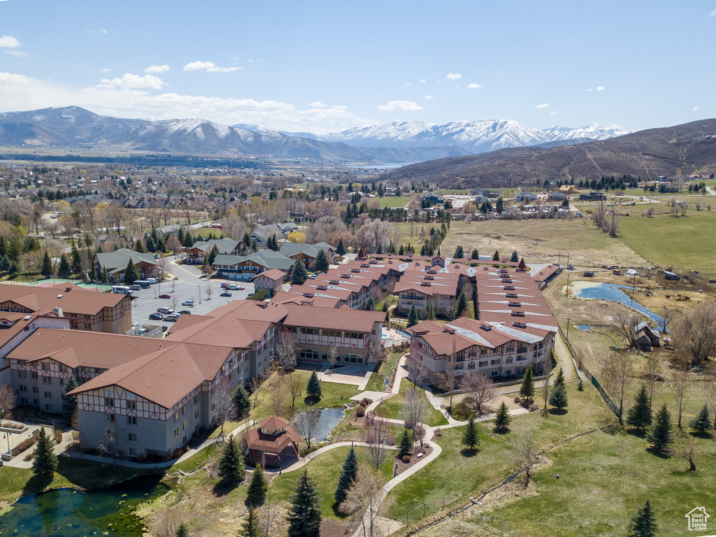 Aerial view of property and surrounding area with a mountain backdrop