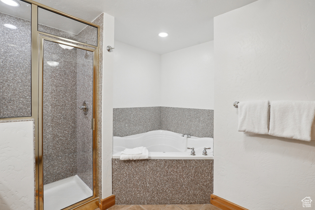 Bathroom featuring a shower stall, tile patterned flooring, a bath, and recessed lighting
