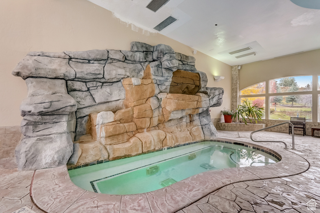 View of swimming pool with a hot tub and a swimming pool