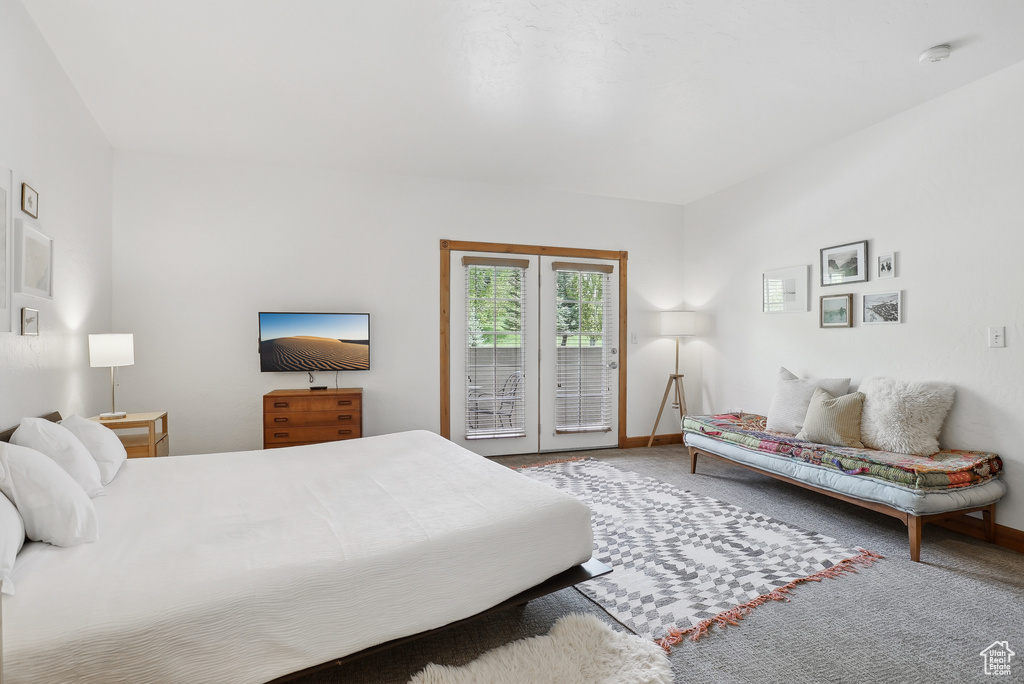 Carpeted bedroom with access to outside and baseboards