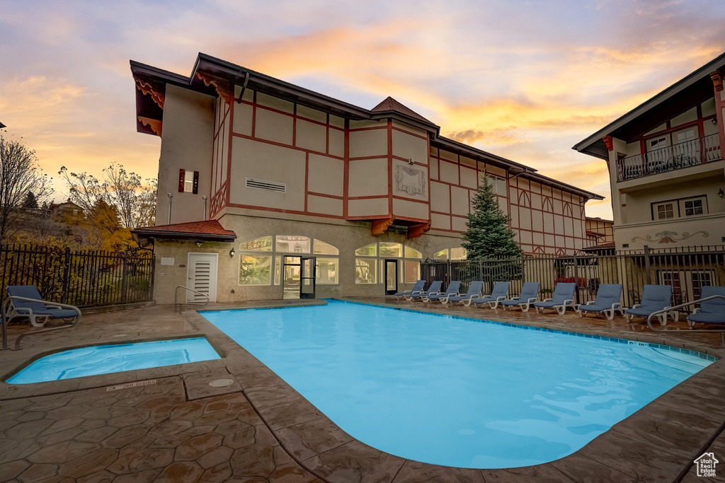 Community pool with a patio