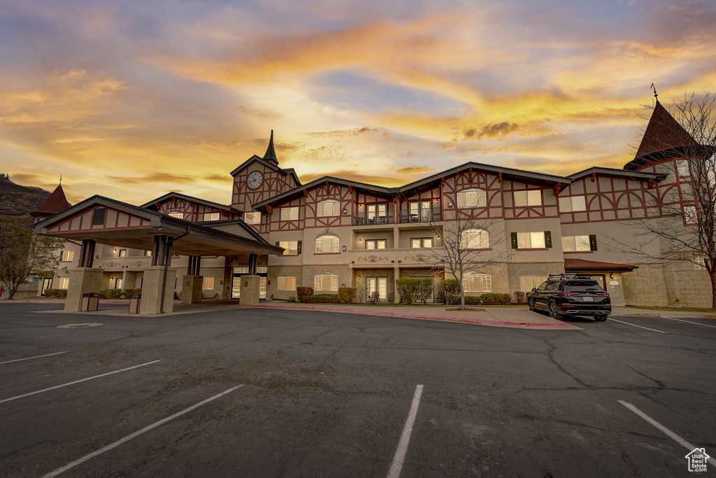 Property at dusk with uncovered parking