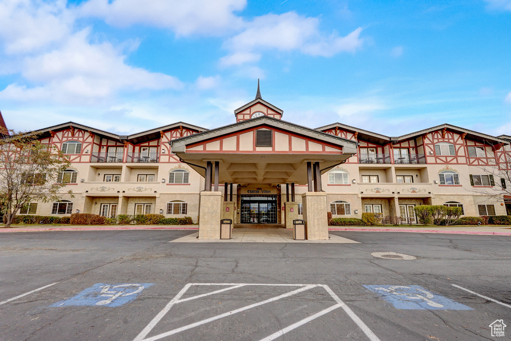 View of building exterior featuring uncovered parking