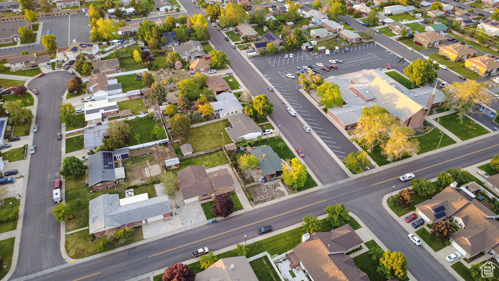 Aerial view of property and surrounding area featuring nearby suburban area