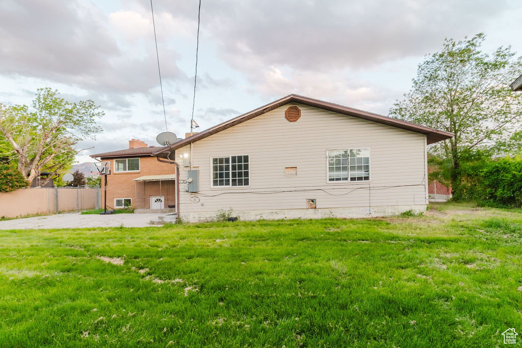 Rear view of house with brick siding and a chimney