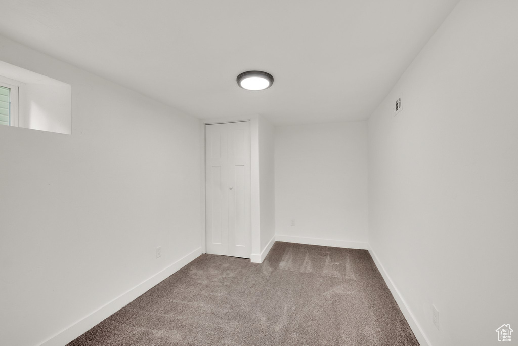 Basement featuring carpet and baseboards