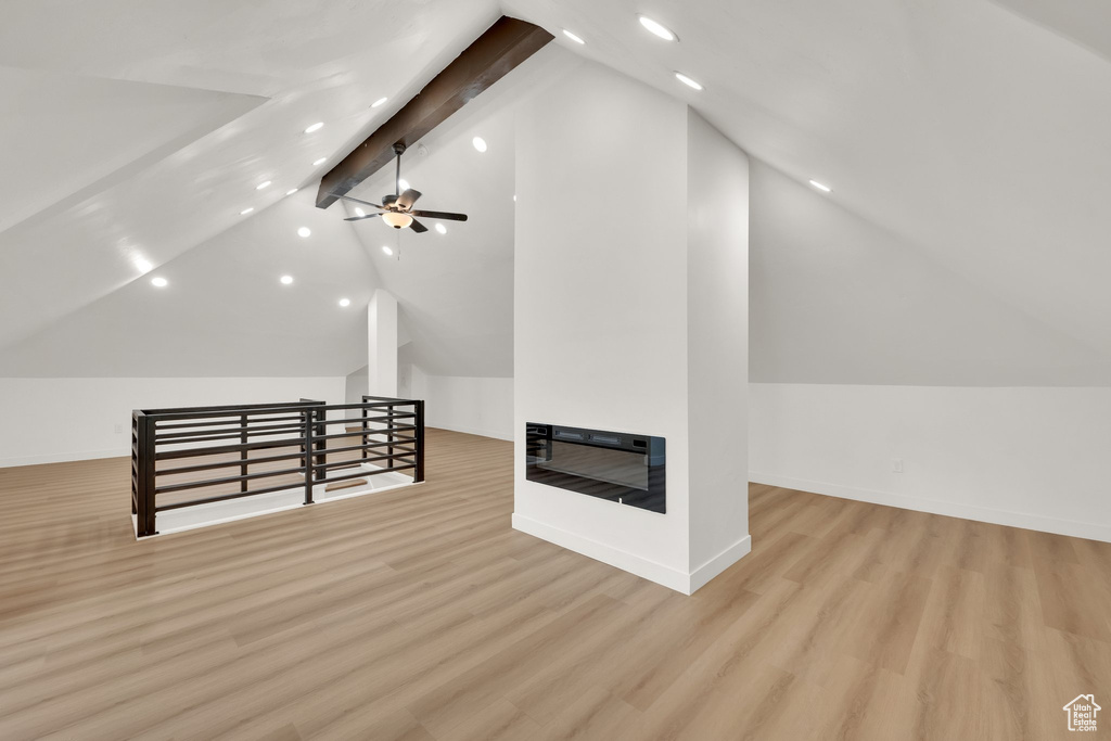 Additional living space with recessed lighting, wood finished floors, baseboards, and ceiling fan