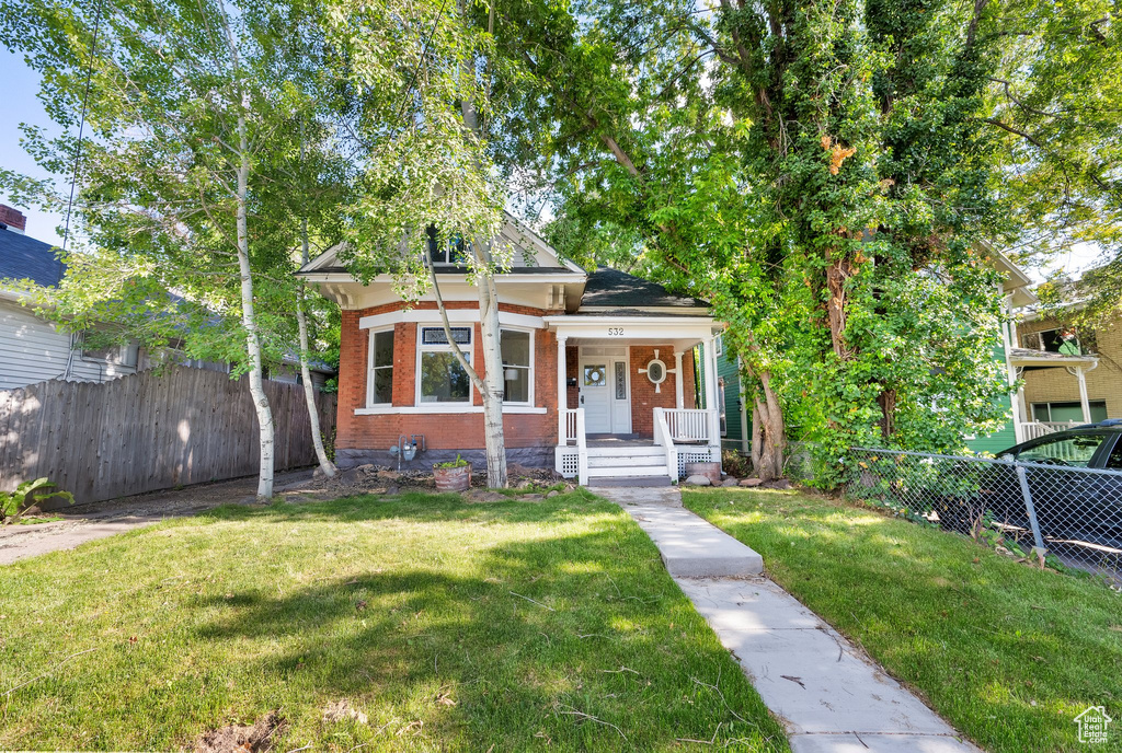 View of front of house featuring brick siding and covered porch
